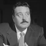 Jackie Gleason in suit and tie - legendary entertainer with $10 million net worth at death in 1987, equivalent to $25 million today