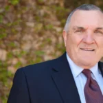 Rudy Ruettiger Net Worth and legacy captured in a motivational sports photo.