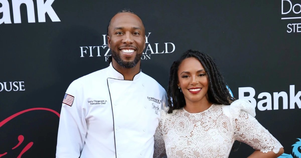 Larry Fitzgerald Wife, Melissa Blakesley, posing with Larry at a public event, both smiling and dressed in elegant attire.