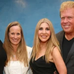 Lori Brice stands smiling with three others at an event, celebrating her achievements and inspiring journey.