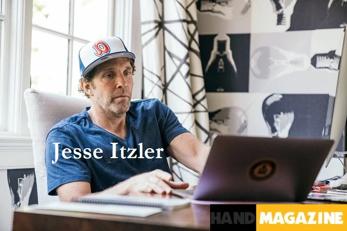 Jesse Itzler speaking at a business conference, sharing insights about entrepreneurship and personal growth with an energetic stance and engaging smile