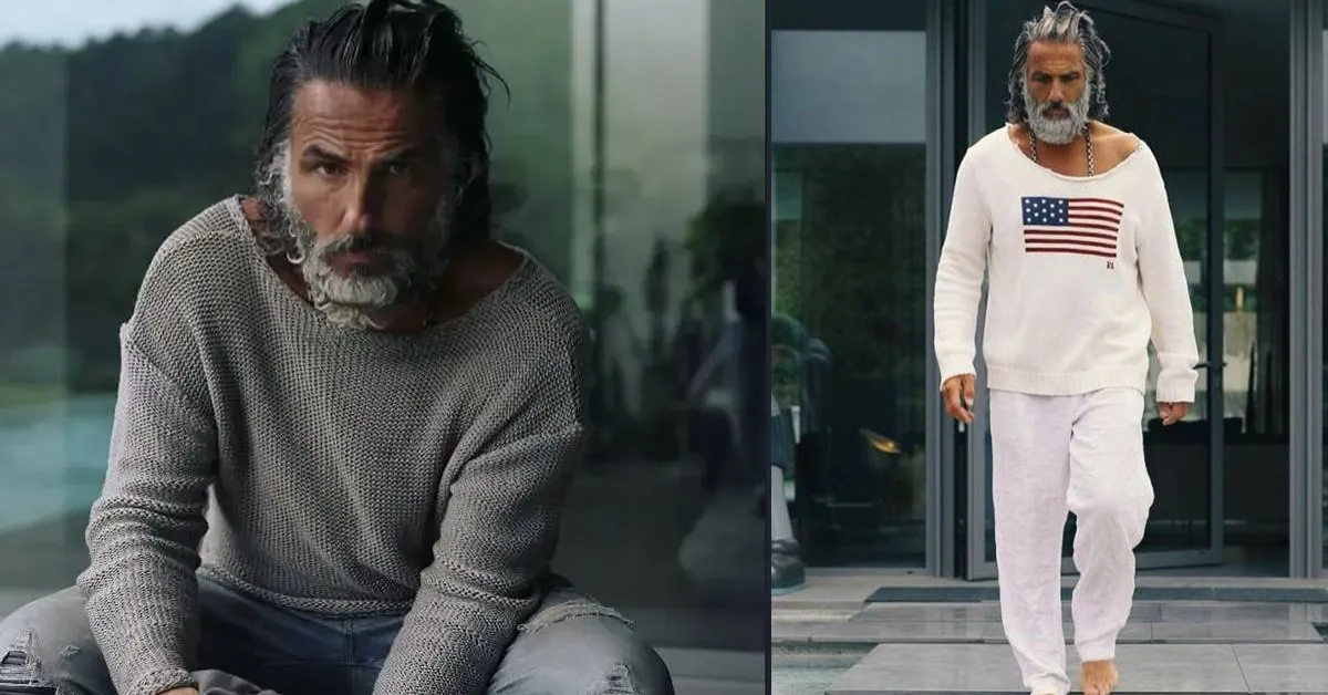 Ilan Tobianah in stylish knit sweater, showcasing his Zeus-like appearance with long gray hair and beard, embodying luxury and success related to Ilan Tobianah Net Worth